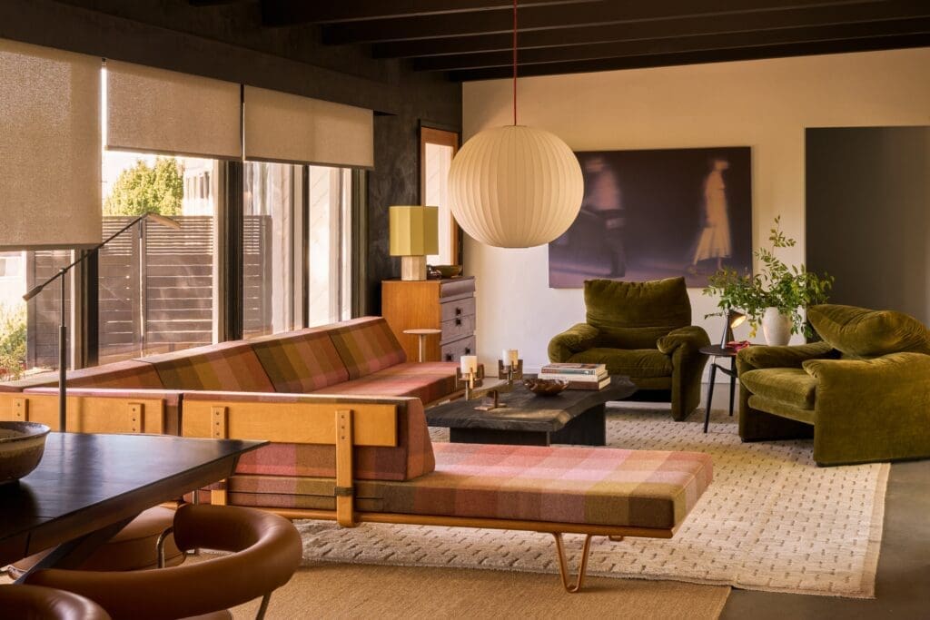 Mid century modern living and dining room at the Brixton project in Pasadena by The Warren interior design featuring a custom plaid sectional sofa, vintage dining chairs, brass chandelier, and floor to ceiling windows.
