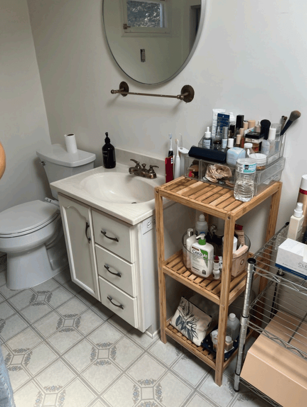 Before the renovation ~ the original small vanity and toilet with peel-and-stick vinyl flooring in the Hollywood Hills bathroom.